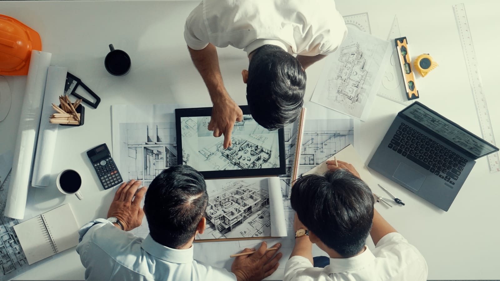 Engineers reviewing blueprints